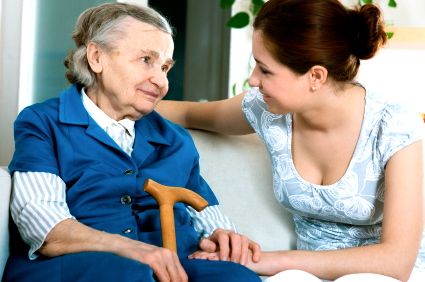 Home caregiver caring for senior woman at home